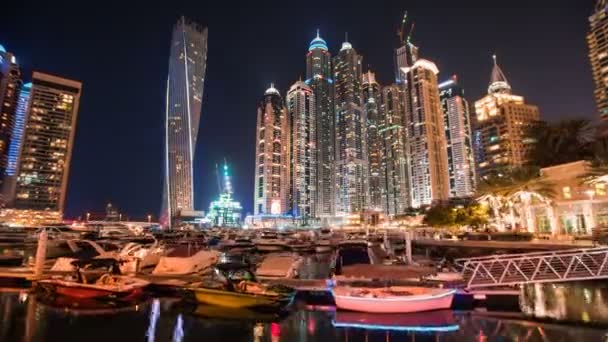 Timelapse view of Dubai Marina skyscrapers with floating yachts and boats, United Arab Emirates — стоковое видео