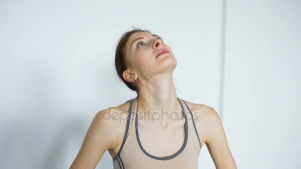 Young woman doing yoga exercise asana on mat indoor — Stock Video