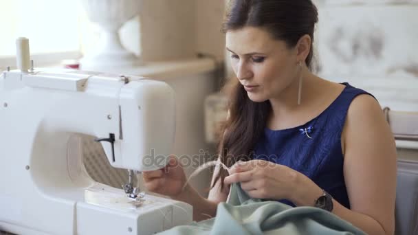 Young clothing designer and seamstress woman work with sewing machine in tailor studio — Stock Video