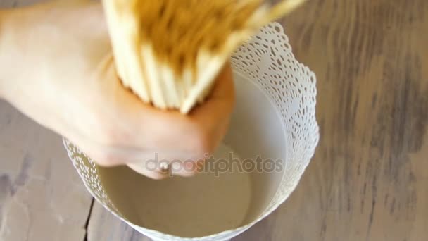 Closeup slow motion of human hand put wooden sticks for food and canape in bucket — Stock Video