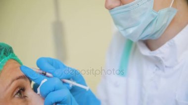 Kozmetik doktor kadın hastasını tıbbi klinikte için botox tıp enjeksiyon yapıyor