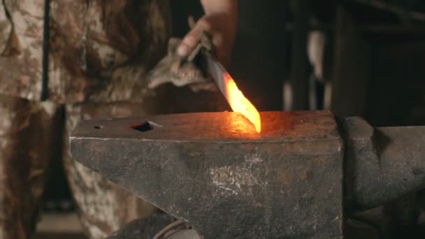 Slowmotion closeup blacksmith hands manually forging hot metal on the anvil in smithy with spark fireworks — Stock Video