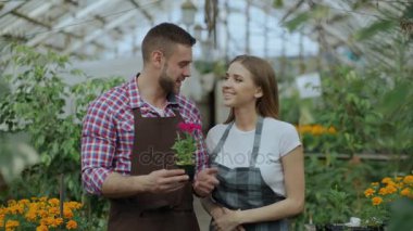 Blogger çift bahçıvanlar çiçek söz ve video blog Bahçe hakkında online vlog için kayıt tutarak önlük gülümseyen genç kadeh kaydırmak