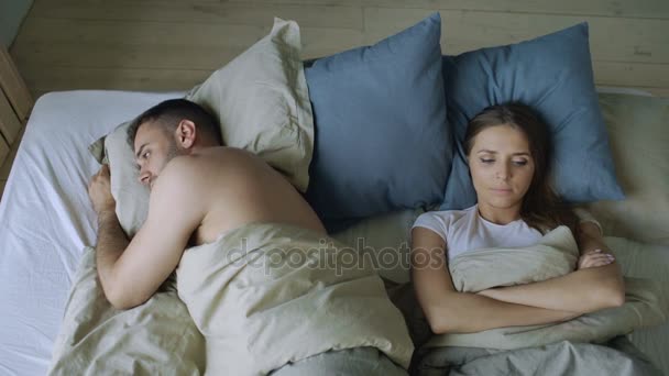 Top view of upset lying sleepless couple in bed offended because of quarrel — Stock Video