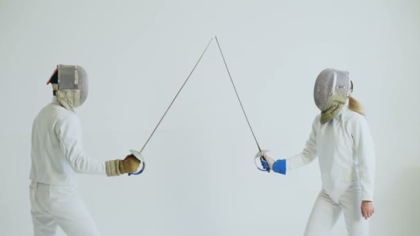 Two fencers have fencing training on white background — Stock Video