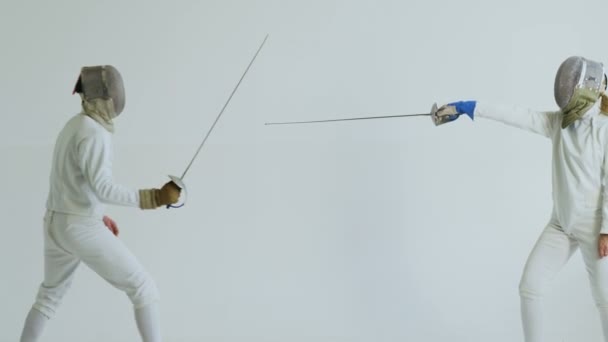 Two fencers having training attack and defence exercises in fencing on white background — Stock Video