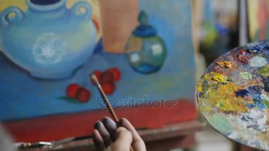Yetenekli sanatçı adam öğretim ve genç kız boyama temelleri Sanat Atölyesi gösterilen yakın çekim