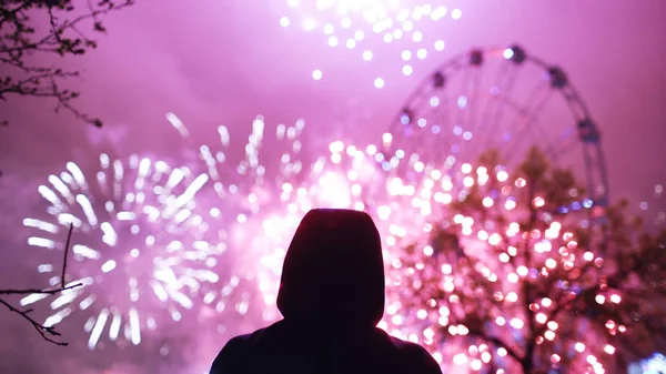 Closeup silhouette of alone man watching fireworks on new year celebration outdoors — Stock Photo, Image