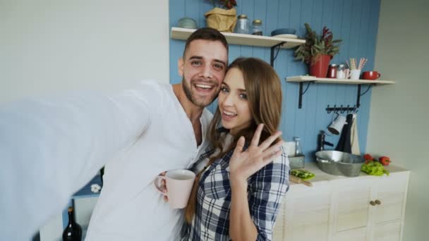 POV de joven feliz pareja tomando fotos selfie mientras desayuna en la cocina en casa — Vídeos de Stock