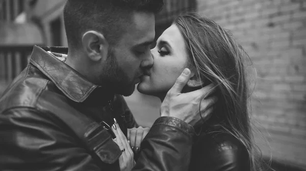 Closeup of happy loving couple kissing and embracing while havinhg walk in city street Royalty Free Stock Photos