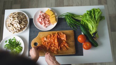 Üstten Görünüm kadının bir ahşap tahta kesme sebze pizza yemek için evde mutfakta eller