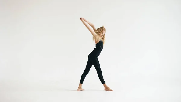 Modern beautiful teenage girl dancer dancing contemporary on white background indoors — Stock Photo, Image