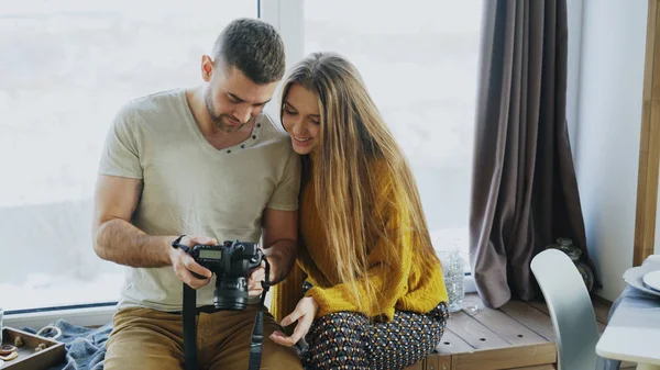 Fotógrafo profissional homem mostrando fotos na câmera digital para menina estudante em materclass pessoal no estúdio de fotografia dentro de casa — Fotografia de Stock