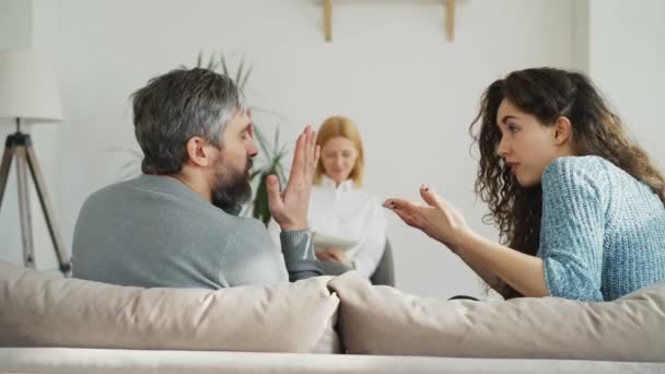 Erfahrene Psychoanalytikerin hört zu und schreibt Notizen, während verheiratete wütende Paare sich streiten und streiten, während sie professionelle Psychologen und Eheberater aufsucht — Stockvideo