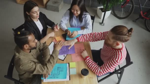 Top view of start-up business team of multi-ethnic people put palms together after successful agreement about new project in modern loft office — Stock Video