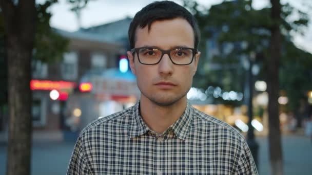 Zpomalený portrét dobře vypadajícího mladého muže s vážnou tváří venku — Stock video