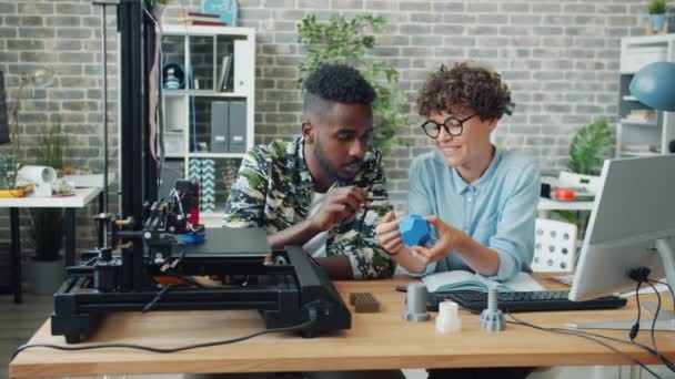 Des gens souriants échangent des idées sur le modèle d'imprimante 3D, l'équipement travaillant dans le bureau — Video