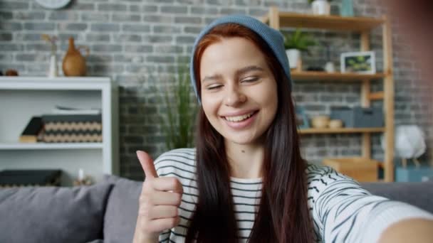 Point of view shot of playful young woman taking selfie smiling at home alone — Stock Video