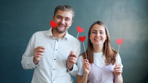 Playful couple holding hearts moving hands smiling feeling happy on Valentines day — Stock Video