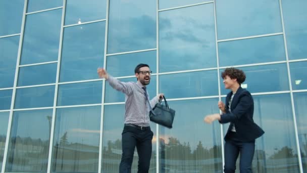 Group of happy businesspeople dancing outdoors in city street having fun together — Stok video