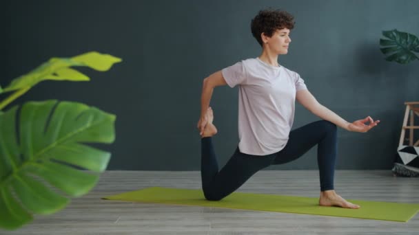 Movimento lento da mulher bonita fazendo ioga no ginásio alongamento concentrado no exercício — Vídeo de Stock