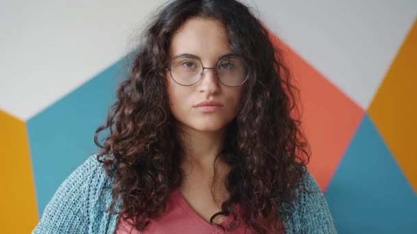 Portrait of attractive Asian girl looking at camera with serious face then smiling — Stock Video