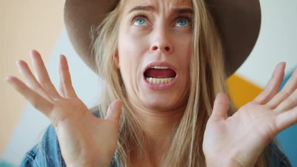 Portrait of playful young woman making funny faces gesturing having fun indoors — Stock Video