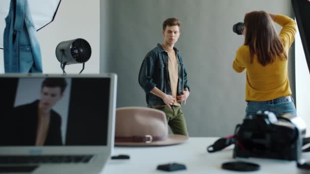 Όμορφος νεαρός που ποζάρει για την κάμερα κατά τη διάρκεια της επαγγελματικής φωτογράφησης στο στούντιο — Αρχείο Βίντεο