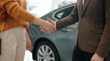Slow motion of male and female hands during handshake, lady taking keys from manager