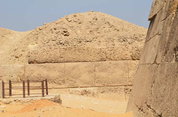 Pyramid in sand dust under gray clouds — Stock Photo, Image