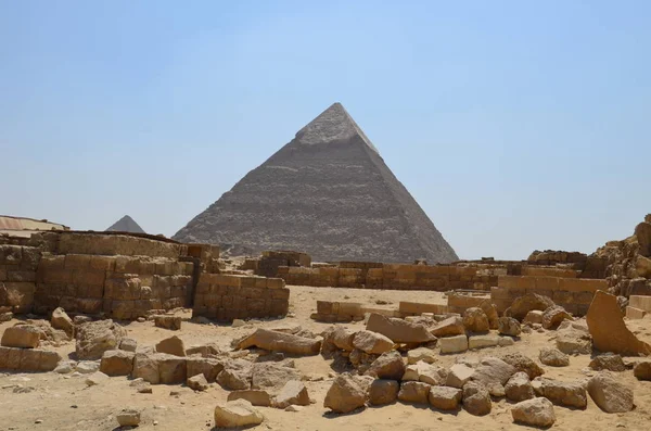 Pyramid in sand dust under gray clouds — Stock Photo, Image