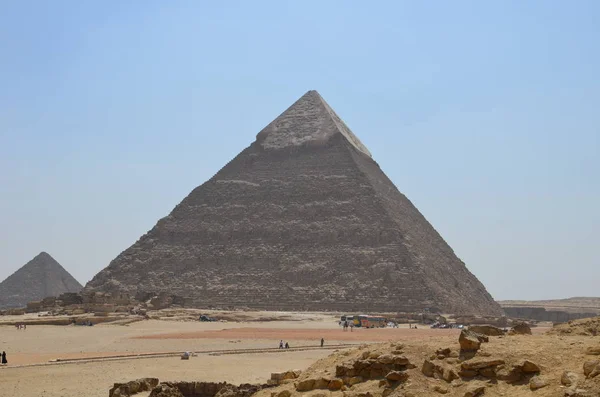 Pyramid in sand dust under gray clouds — Stock Photo, Image