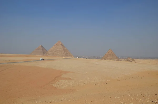 Gri bulutlar altında kum toz içinde piramit — Stok fotoğraf