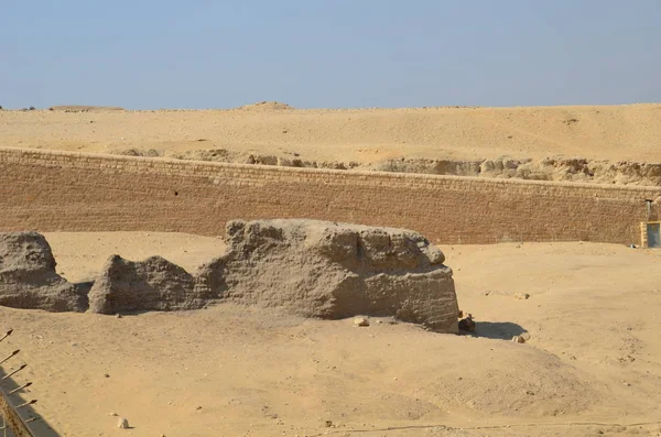 Pyramid in sand dust under gray clouds — Stock Photo, Image