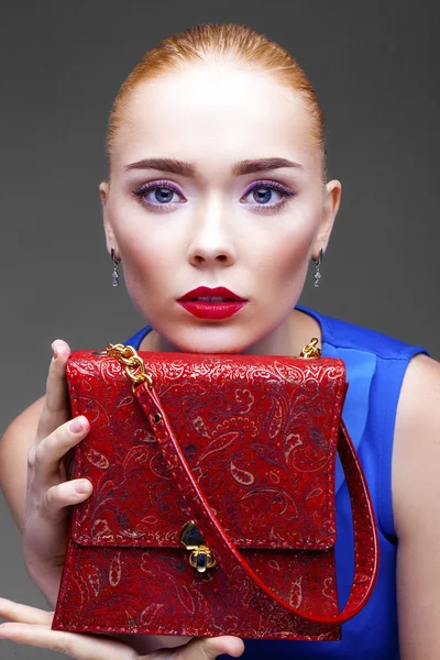 Blonde woman with bright makeup posing at studio isolated on gra — Stock Photo, Image