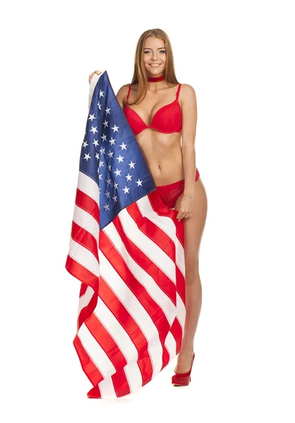 Piękna dziewczyna w bikini, trzymając flagę Usa — Zdjęcie stockowe