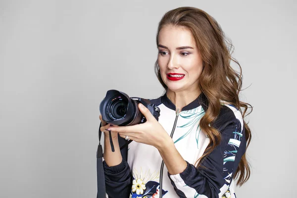 Young cheerful woman taking a picture over white background — Stock Photo, Image