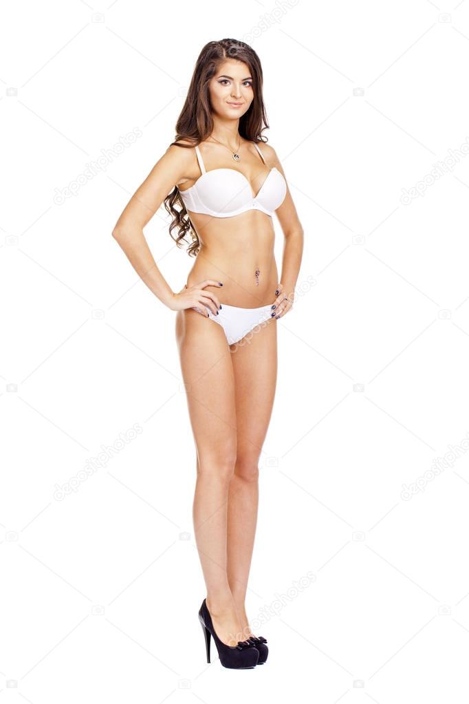 Full length portrait of young woman wearing white bikini
