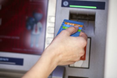 Female arms Take cash from the ATM