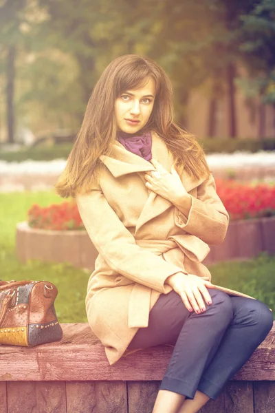 Porträt einer jungen schönen Frau im beigen Mantel — Stockfoto