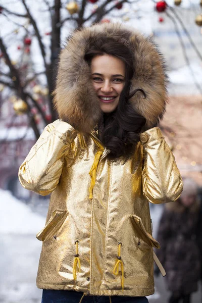 Young beautiful woman in golden jacket — Stock Photo, Image