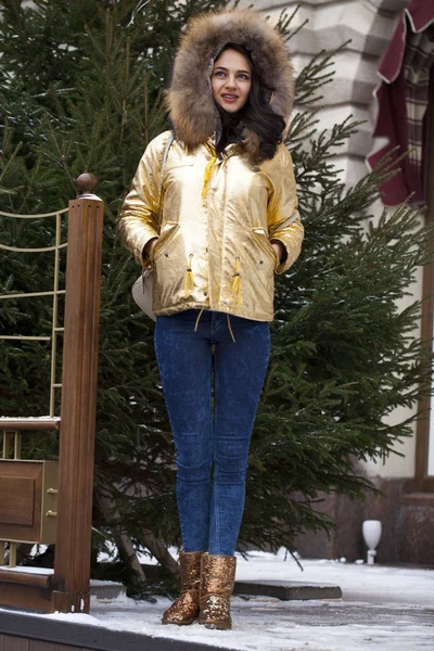 Young beautiful woman in golden jacket — Stock Photo, Image