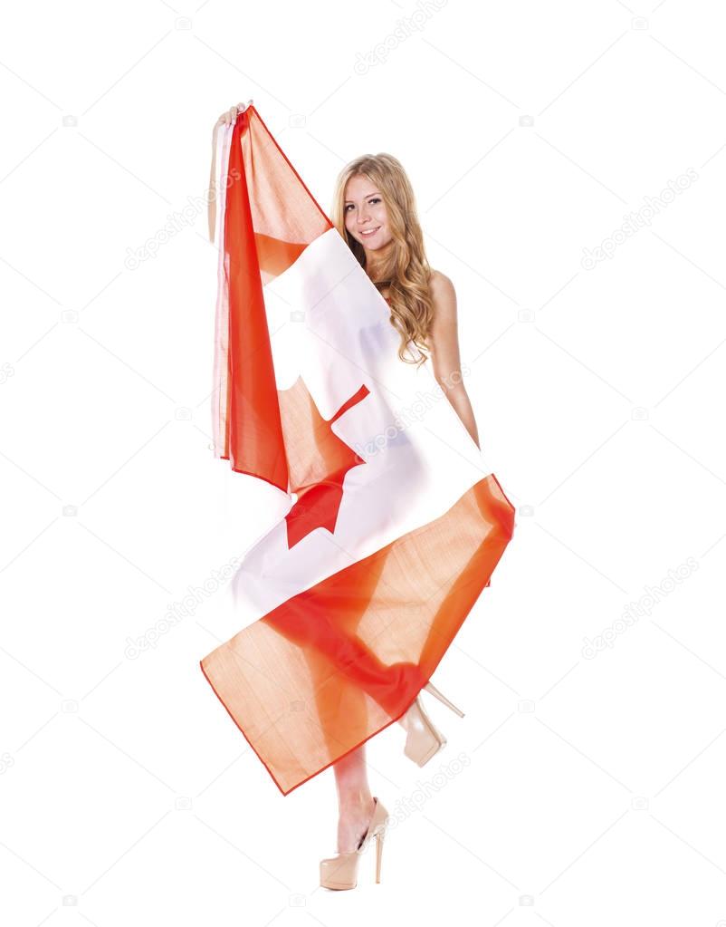Beautiful blonde woman holding a large Canadian flag