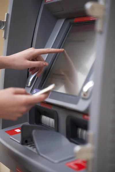 Female hands on the ATM display — Stock Photo, Image