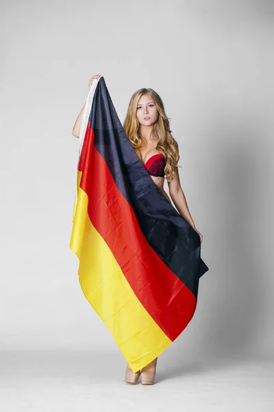 Young woman holds up a clear flag of Germany — Stock Photo, Image