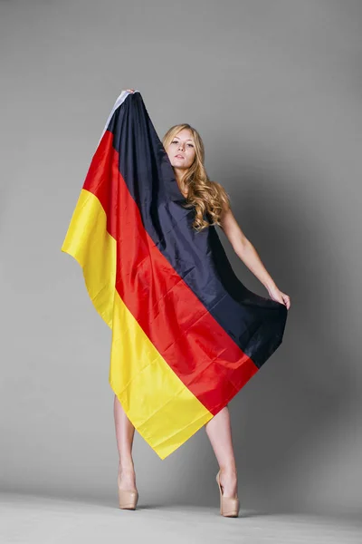 Young woman holds up a clear flag of Germany — Stock Photo, Image