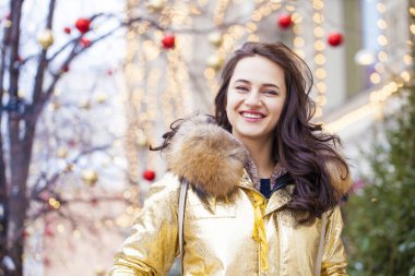 Altın ceketi giyen genç güzel kadın 