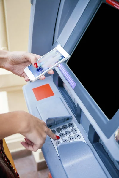 Close up of hand entering pin at an ATM. Finger about to press a — Stock Photo, Image