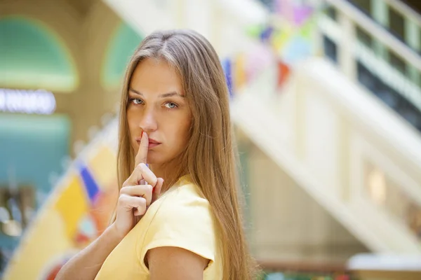 Young beautiful blonde woman has put forefinger to lips as sign — Stock Photo, Image