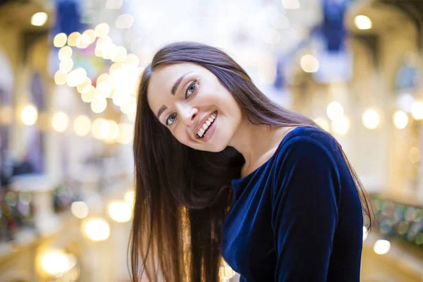 Young beautiful brunette woman in dark blue dress — Stock Photo, Image